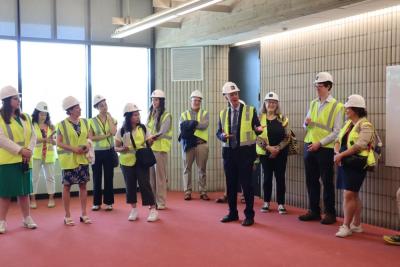 The guests explore a finished classroom, without the furniture placed in. 