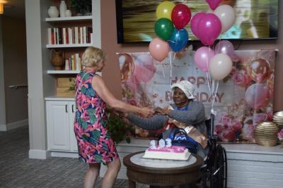 Nellie Jackson dances with one of the staff members. 