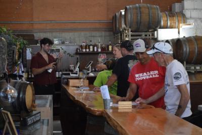 Bikers and friends enjoy drinks at Running Brook Vineyards. 