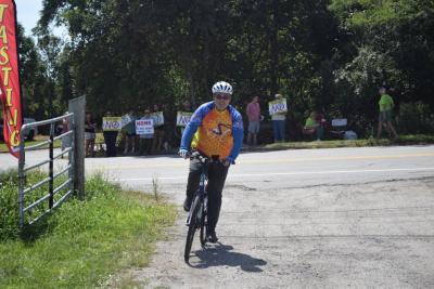 Scott Kane, from Lynn, bikes into the vineyard. 