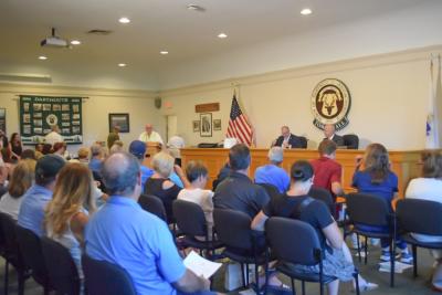 The room was filled and overflowing for the debate. 