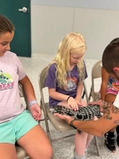 A camper holda a snake. Source: Humane Society and Shelter Southcoast Facebook
