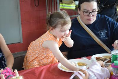 Magnolia Seland, age 2, enjoys the pulled pork. 