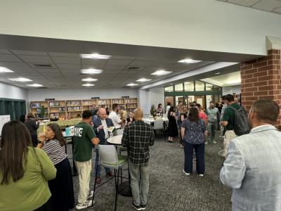 The new teachers, School Committee and mentors mingle. 