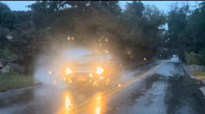 A car driving through a puddle. 