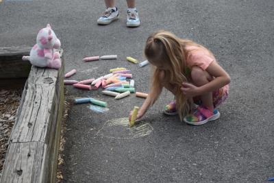 Autumn, age 5, draws some sunshine on the playground. 