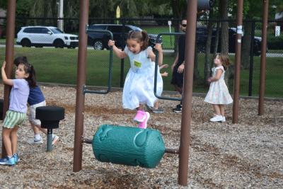 Claire, 5, runs on a playground toy.