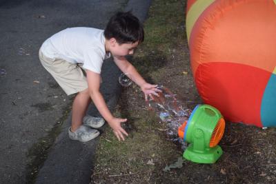 Everett, 6, plays with a bubble machine. 