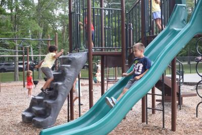 Conner, 6, slides down the slide. 