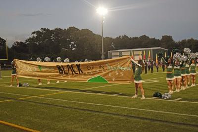 The banner stating the motto of the game, "White out the stands, black out the score board." Photos by Kat Sheridan