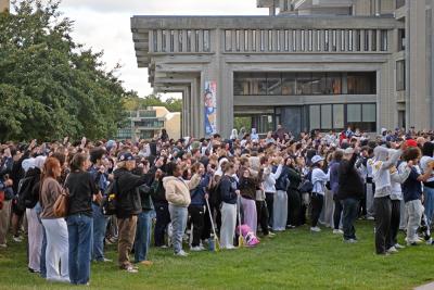 The students hold up candles in Antoine's memory. 