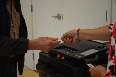 A voter gets an "I Voted" sticker. 