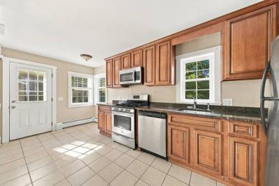 Kitchen with wood cabinets, a gas range and stainless dishwasher at 17 Beeden Road, Westport, MA