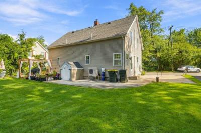 Rear of 17 Beeden Road with a patio, storage shed and wide lawn, Westport, MA