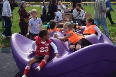 Some of the girls play on the playground. 