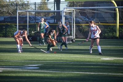 A number of players head for the ball. 