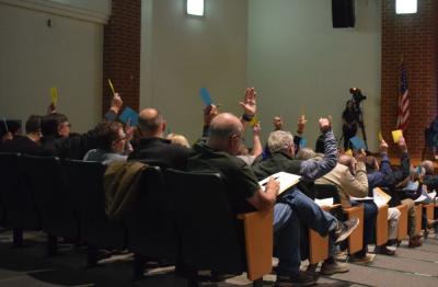 Town Meeting members vote to approve an article. 