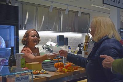 Quiggs hands out samples of cheeses. 