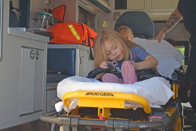 Hazely, age 4, buckles herself into the ambulance. 