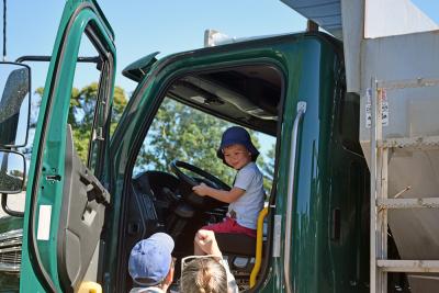 Bo, age 3, enjoys one of the DPW trucks. 