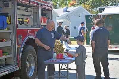 Abraham gets some free fire department merch. 