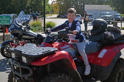 Theodore Nelson, age 3, gets to try out a (stationary) motorcycle. 
