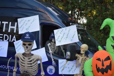 The DCTV van all decorated with skeleton puns. 