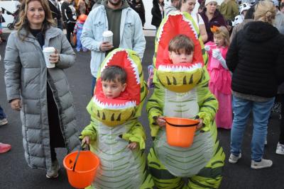 Jones (4) and Lion (7) dressed as matching dinosaurs. 
