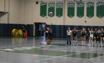 Brianna Ledesma Gassman serves the ball. 