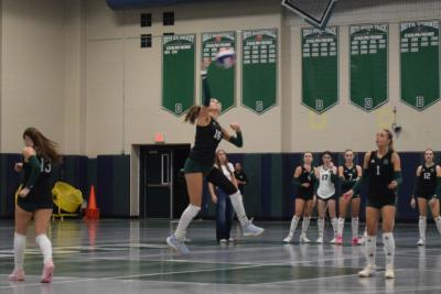 Kasey Pomfret leaps to hit the ball. 