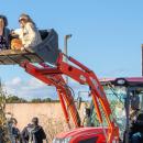 Two attendees at Running Brook Vineyard's harvest festival take a ride in a tractor on Sunday, Oct. 26. Photo by Abby Van Selous T