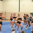 The cheerleaders practice their routine. 