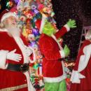 The Grinch and Clauses wave to the crowd in front of the buoy tree. Photo by Michael T. Morris Photography