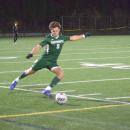 Carter Brennan kicks the ball back into play.