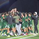 The team celebrates with their trophy.
