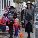 The Cloutier-Howe family walks trick-or-treats. 