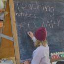 A child writes down what she will be doing to spread light in her community. 