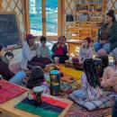 Kids gather around as Samia Walker as she teaches about Kwanzaa.