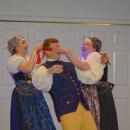 The women blindfold the man as a part of the Śląsk.