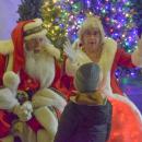 Mr. and Mrs. Santa Claus ask a child what he wants for Christmas.