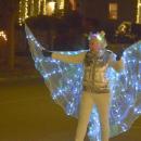 A woman dressed as a illuminated angel. 