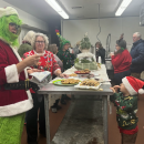 Lincoln Manely peeks at the Grinch from behind the cookie table. 