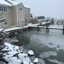 A snowy house on the water. Photo by Mari Huglin