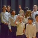 Students from the Potter School wave to family. Photo by Kat Sheridan