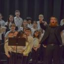 Music teacher Cameron Siegal prompts the crowd to participate. Photo by Kat Sheridan
