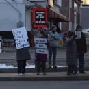 A number of signs protesting the deportation of immigrants.