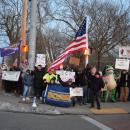 Protesters pose on the corner at the border of New Bedford and Dartmouth.