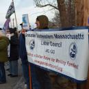 A labor organization holds their sign.