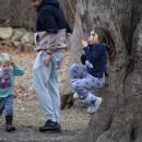 A four-year-old plays on the rope swing.