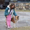 IvyRose Nelson, 8, pets the farm dog.